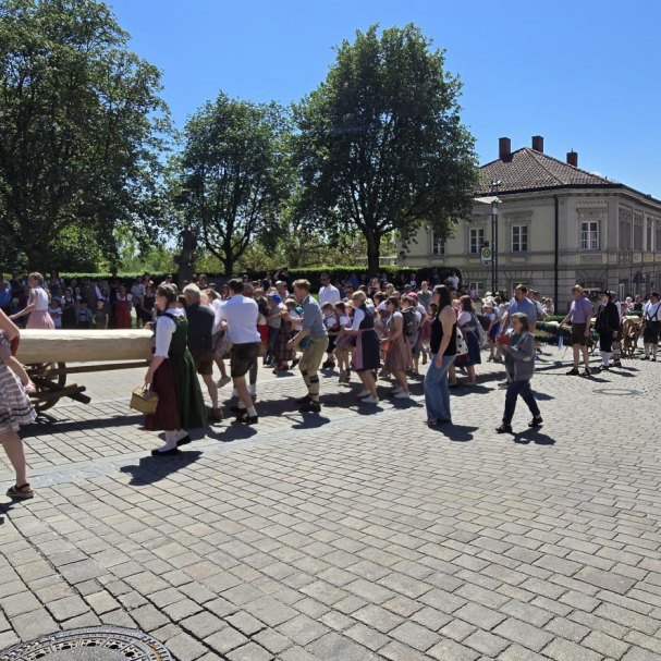 Kinder sitzen auf dem Maibaum